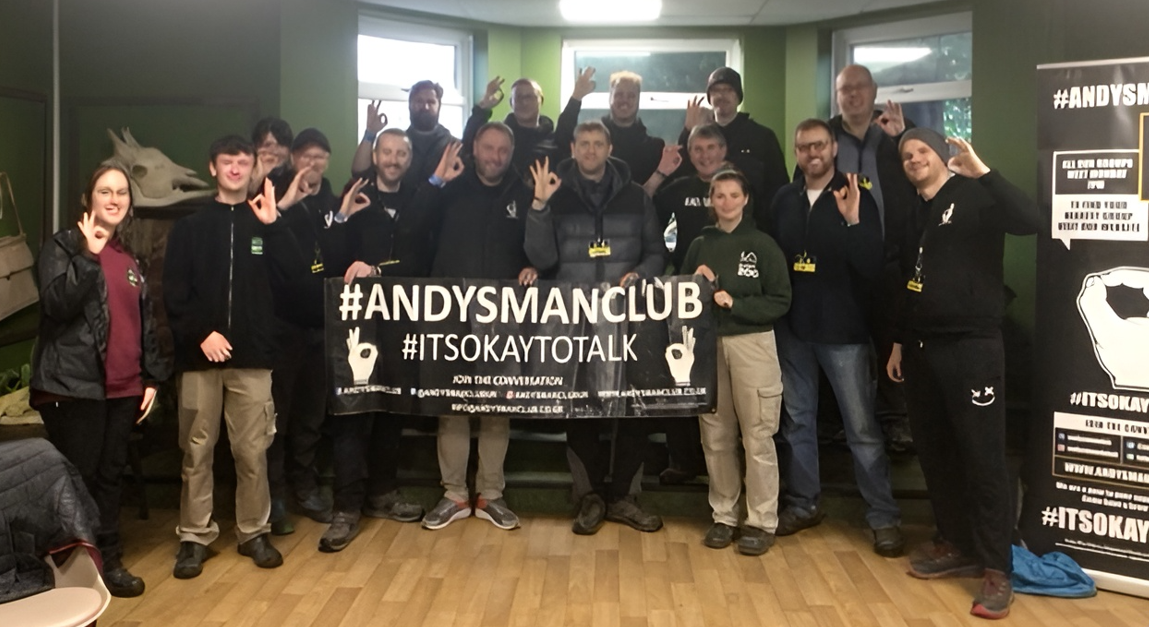 A group holding a sign which reads #AndysManclub #itsokaytotalk